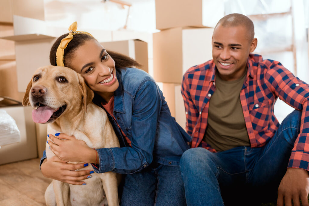 young black couple with dog in new apartment