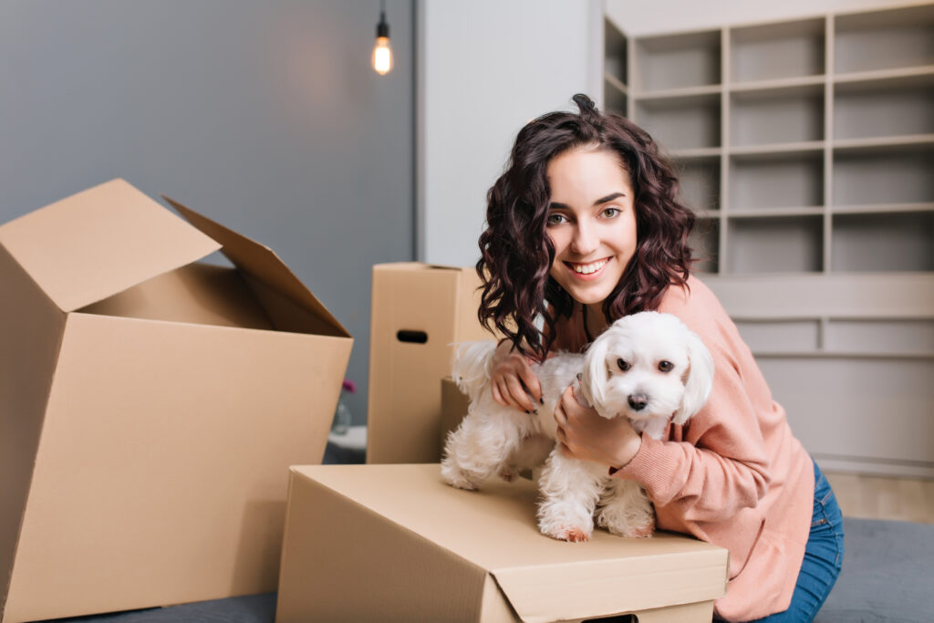 young woman with dog new apartment moving in