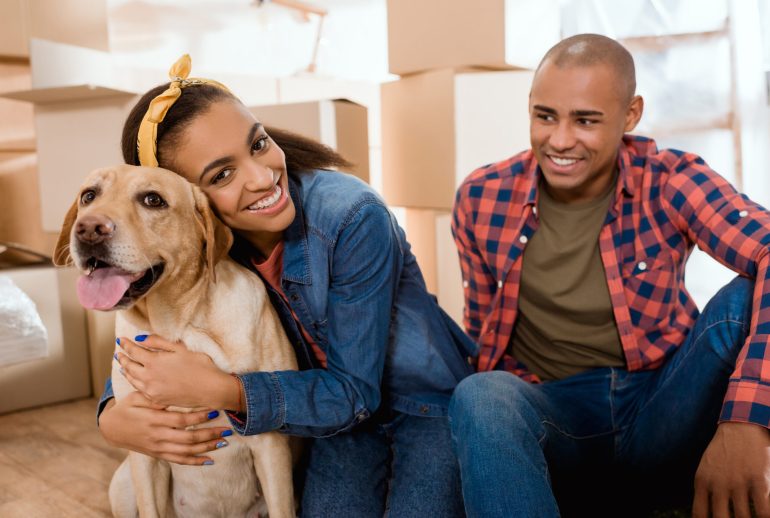 young black couple with dog in new apartment